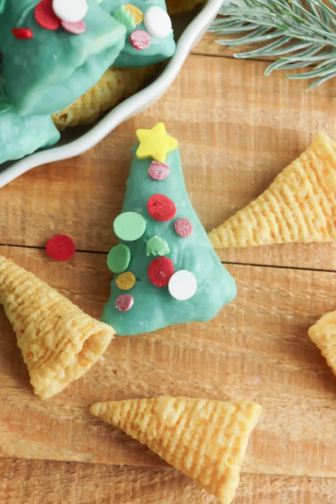 Christmas Tree Bugles - Cultivating Brilliant Minds bugles covered in green melted chocolate and sprinkles to look like christmas trees