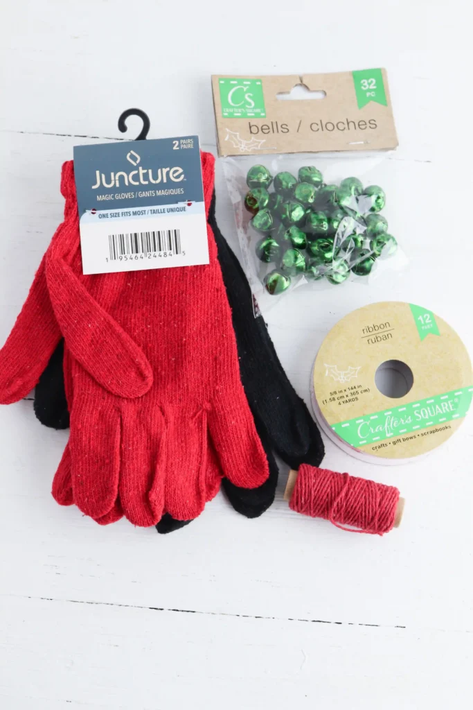 red gloves, red and white striped ribbon, green jingle bells, and red string