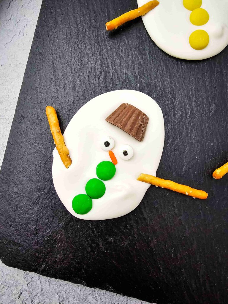 Melted Snowman Chocolate Bark - Cultivating Brilliant Minds White chocolate bark decorated to look like melted snowmen