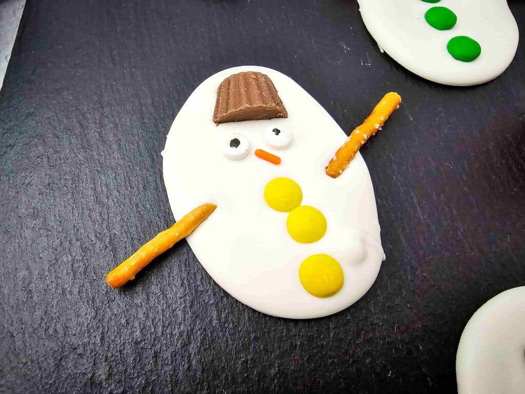 Melted Snowman Chocolate Bark - Cultivating Brilliant Minds White chocolate bark decorated to look like melted snowmen