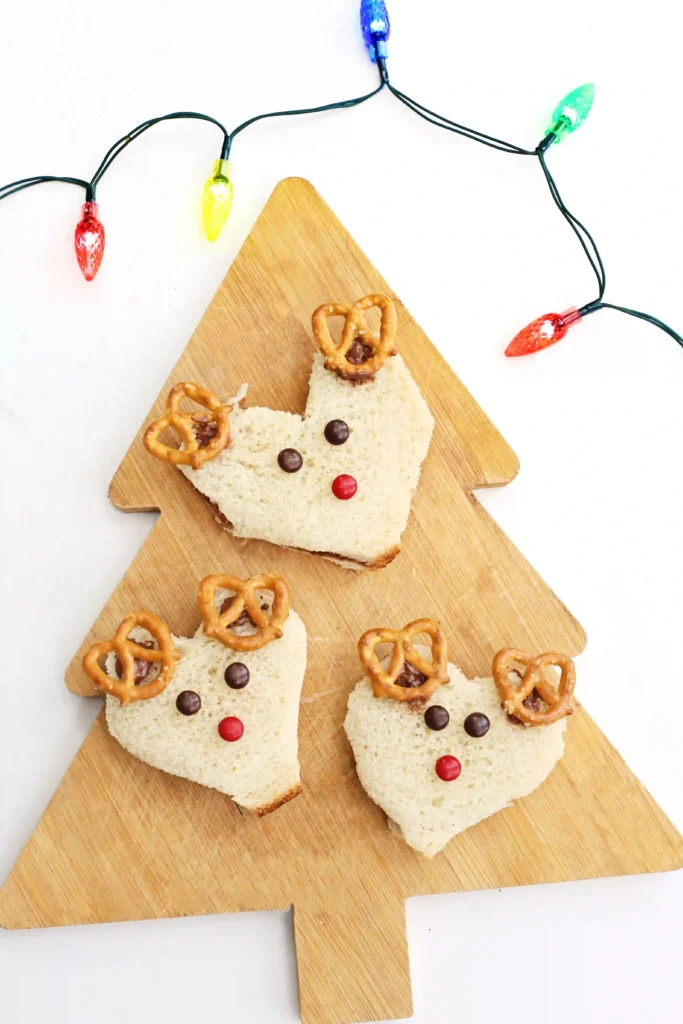 Nutella Reindeer Sandwiches - Cultivating Brilliant Minds nutella sandwiches cut and decorated with m&ms and pretzels to look like a reindeer