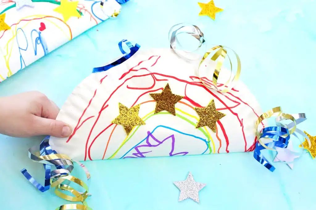 Paper Plate Noisemaker Craft - Cultivating Brilliant Minds a paper plate decorated and glued together with corn inside to make a noisemaker craft