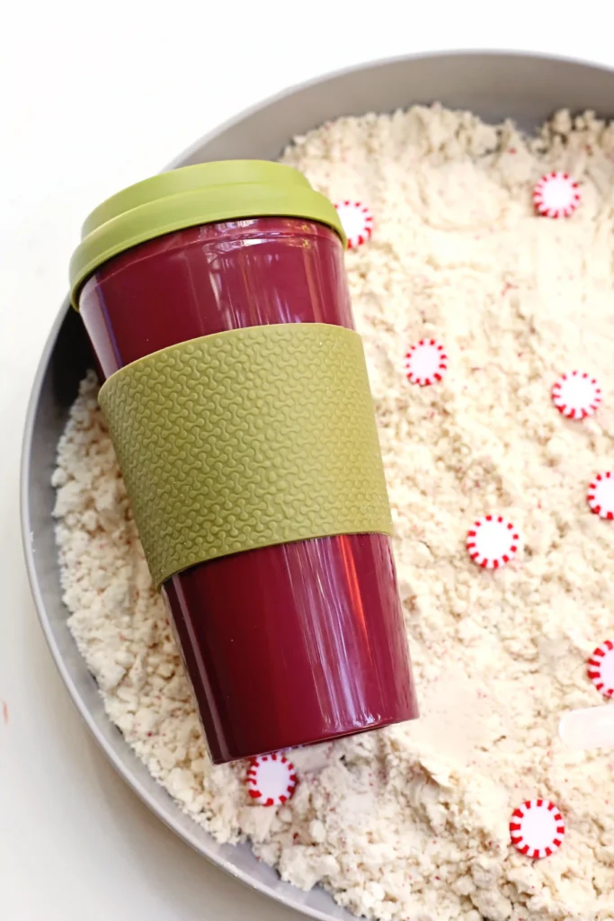 Peppermint Latte Cloud Dough Tray - Cultivating Brilliant Minds a reusable coffee cup in a cloud dough tray filled with peppermints