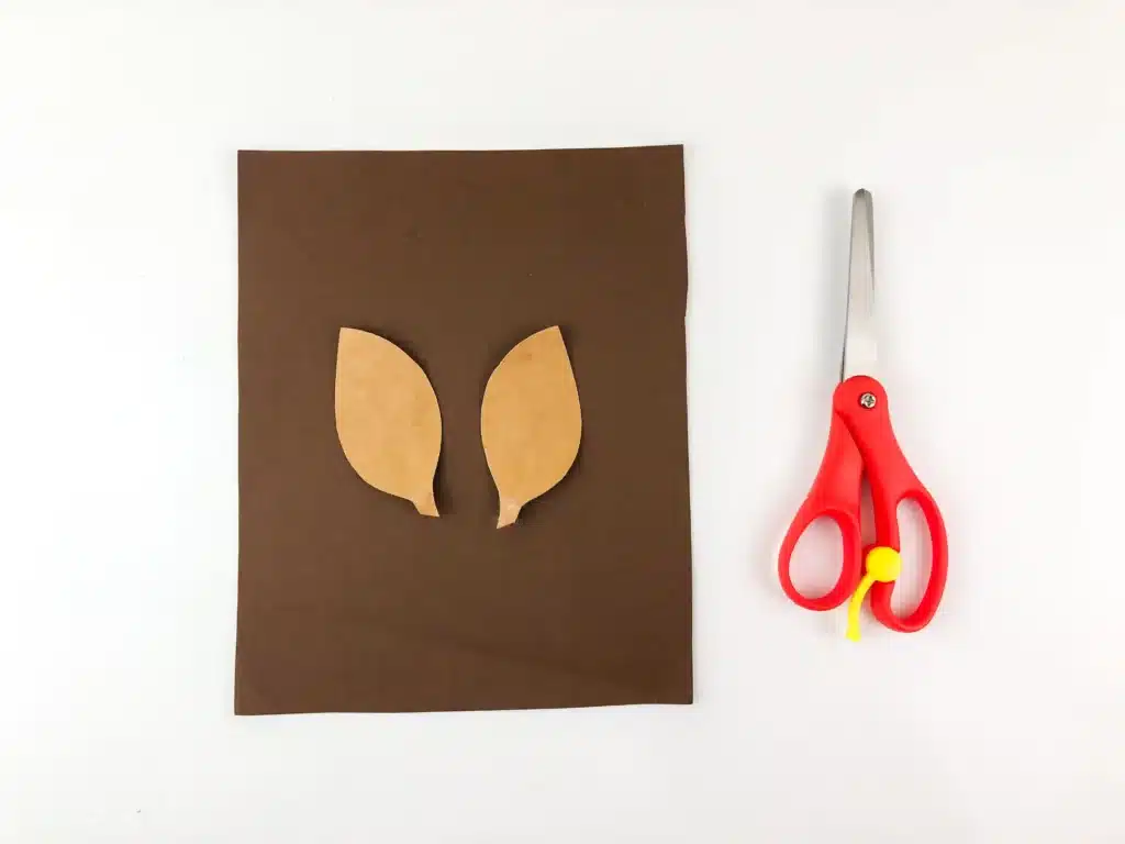 Reindeer Popsicle Stick Ornament Craft - Cultivating Brilliant Minds reindeer ears cut out of brown construction paper