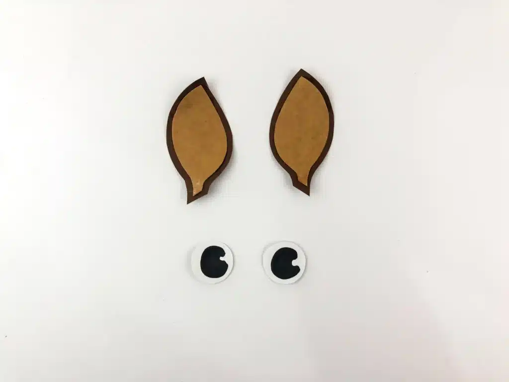 Reindeer Popsicle Stick Ornament Craft - Cultivating Brilliant Minds reindeer ears and eyes cut out of construction paper