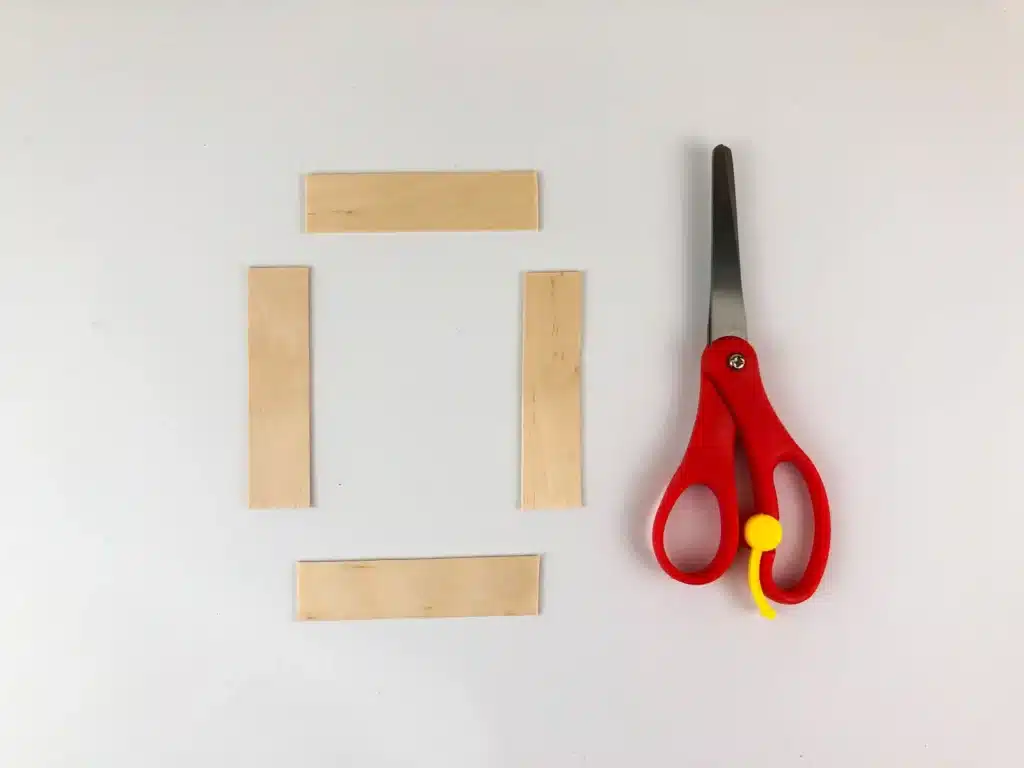 Santa Popsicle Stick Ornament Craft - Cultivating Brilliant Minds popsicle sticks cut into four small strips