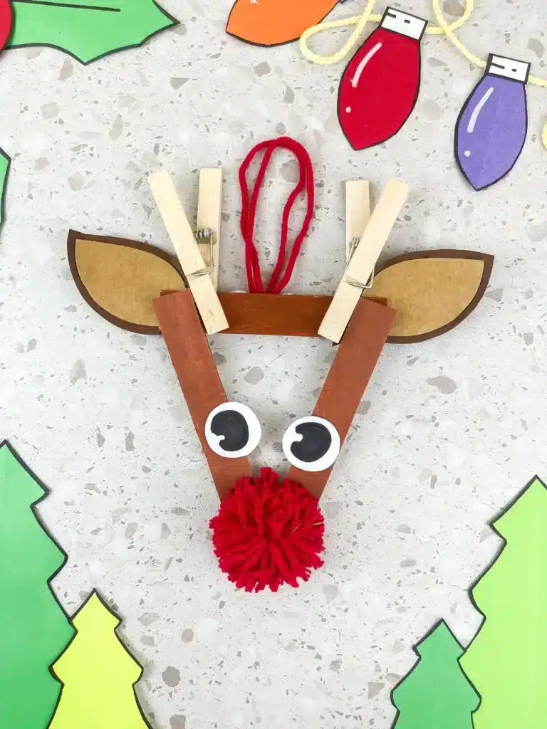 an ornament craft made of popsicle sticks that looks like a reindeer