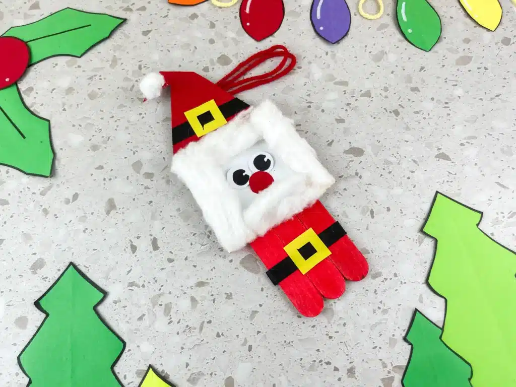 Santa Popsicle Stick Ornament Craft - Cultivating Brilliant Minds a santa ornament made with popsicle sticks and construction paper