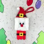 Santa Popsicle Stick Ornament Craft - Cultivating Brilliant Minds a santa ornament made with popsicle sticks and construction paper