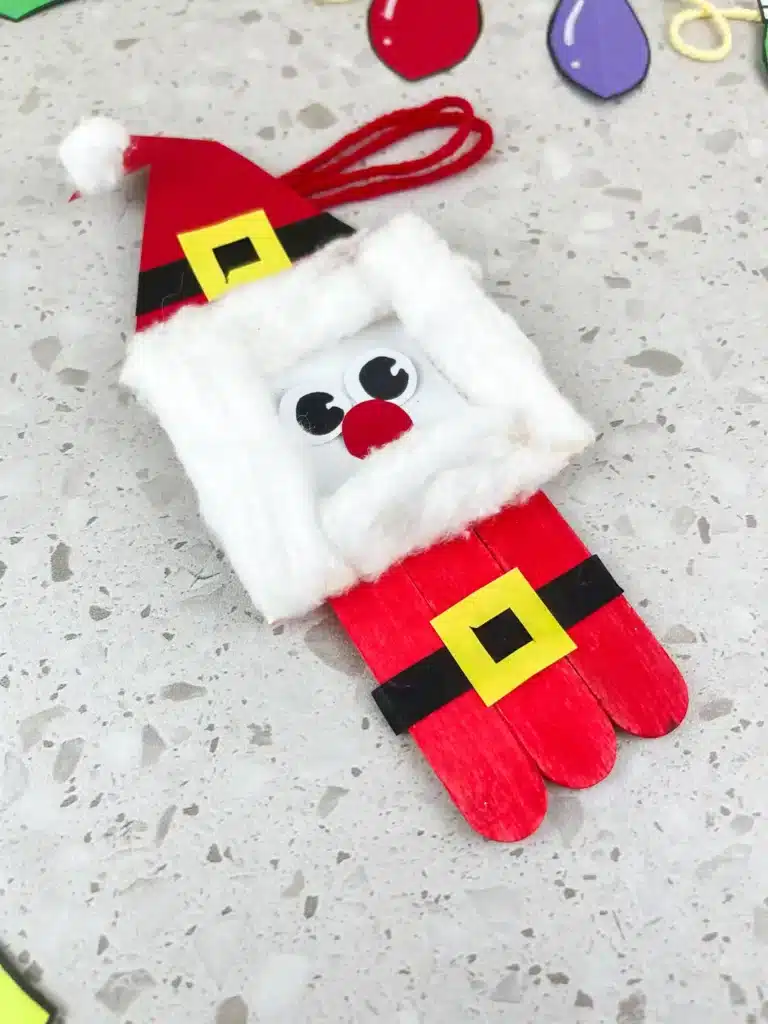 Santa Popsicle Stick Ornament Craft - Cultivating Brilliant Minds a santa ornament made with popsicle sticks and construction paper