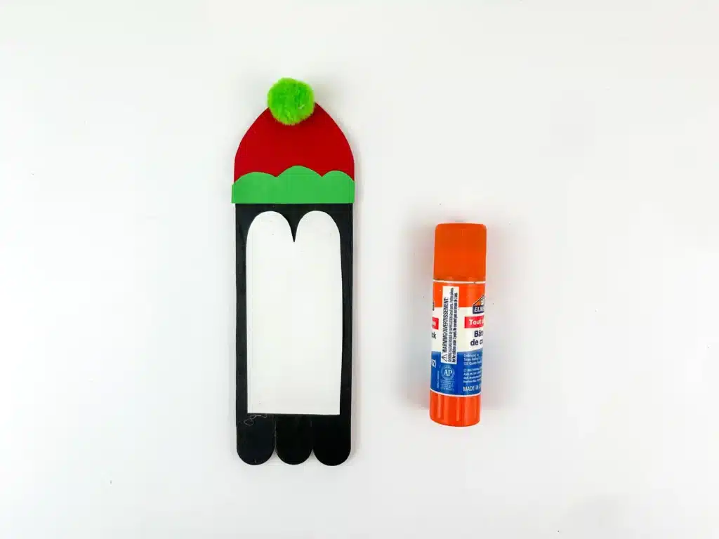 Penguin Ornament Craft - Cultivating Brilliant Minds a penguin made out of popsicle sticks and construction paper