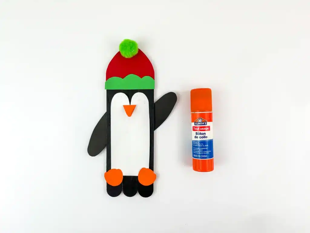 Penguin Ornament Craft - Cultivating Brilliant Minds a penguin made out of popsicle sticks and construction paper