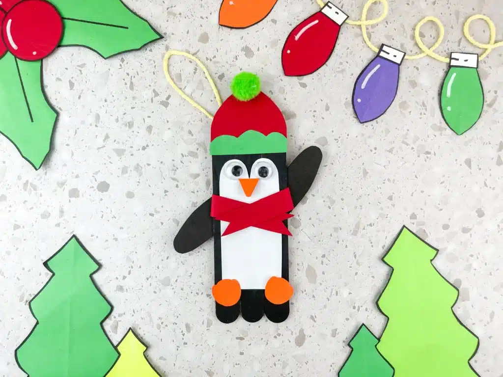 Penguin Ornament Craft - Cultivating Brilliant Minds a penguin made out of popsicle sticks and construction paper