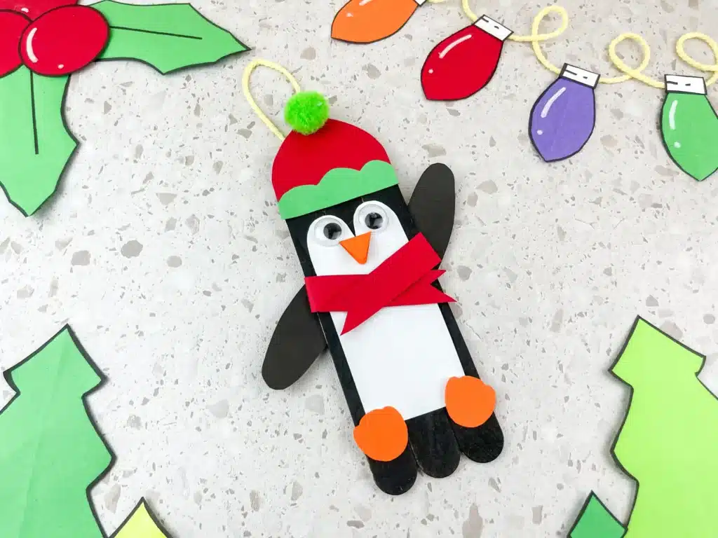 Penguin Ornament Craft - Cultivating Brilliant Minds a penguin made out of popsicle sticks and construction paper