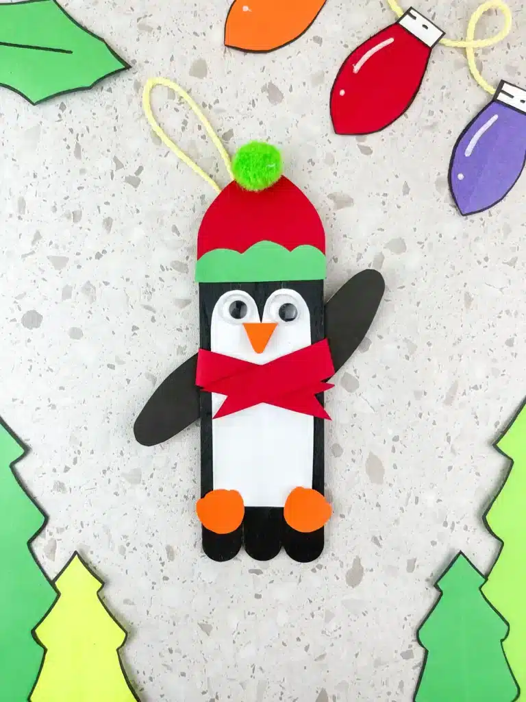 Penguin Ornament Craft - Cultivating Brilliant Minds a penguin made out of popsicle sticks and construction paper