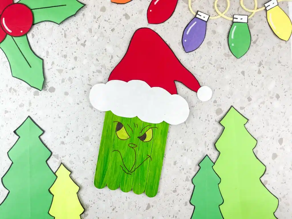 Grinch Popsicle Stick Craft - Cultivating Brilliant Minds grinch popsicle stick craft: popsicle sticks colored to look like the grinch