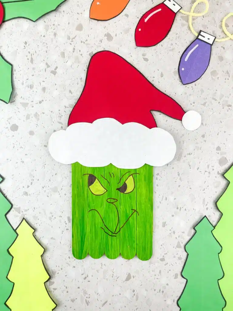 Grinch Popsicle Stick Craft - Cultivating Brilliant Minds grinch popsicle stick craft: popsicle sticks colored to look like the grinch