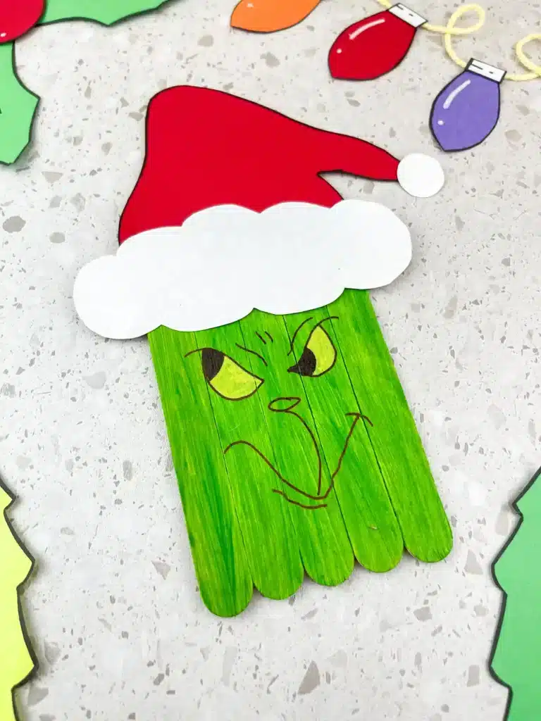 Grinch Popsicle Stick Craft - Cultivating Brilliant Minds grinch popsicle stick craft: popsicle sticks colored to look like the grinch