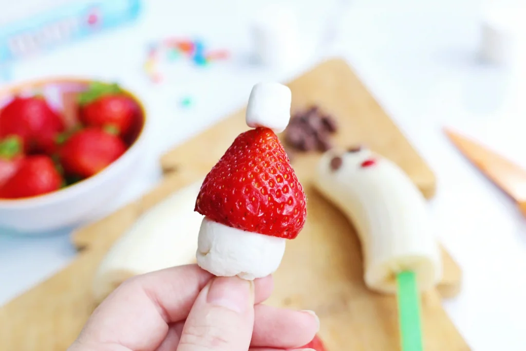 Banana Santa: A Healthy Christmas Snack - Cultivating Brilliant Minds a santa hat made of strawberries and marshmallows