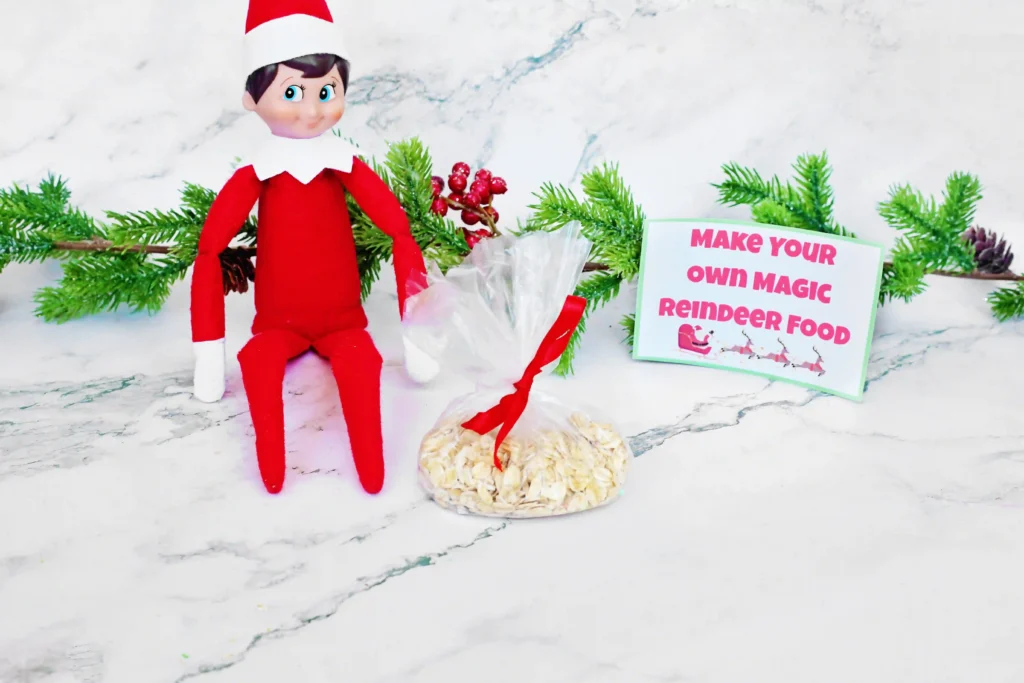 Elf on the Shelf Reindeer Food Craft - Cultivating Brilliant Minds elf on the shelf next to a bag of oats and glitter and a sign that reads "make your own magic reindeer food"