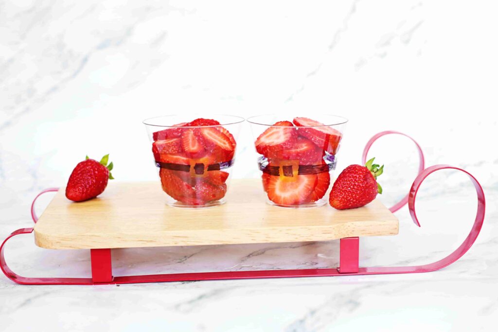 Santa Fruit Cups - Cultivating Brilliant Minds Sliced strawberries in a cup decorated to look like santa's suit