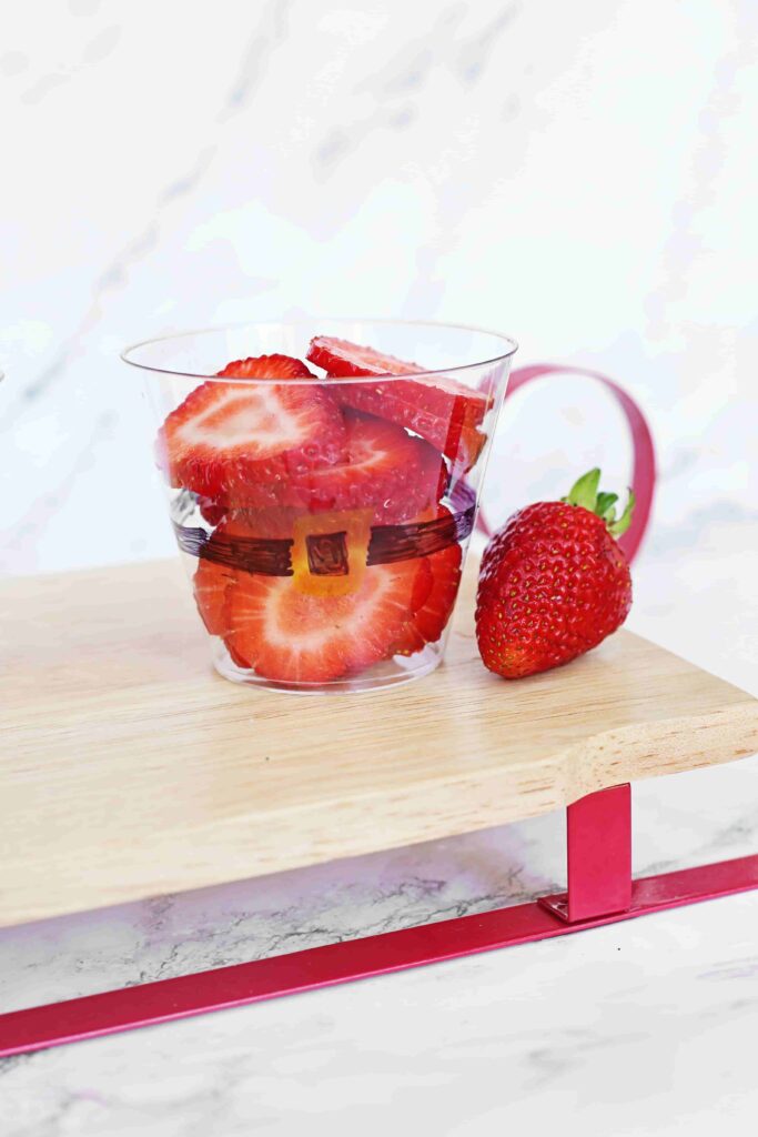 Santa Fruit Cups - Cultivating Brilliant Minds Sliced strawberries in a cup decorated to look like santa's suit