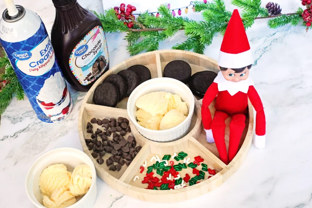 Elf on the Shelf Idea - Cultivating Brilliant Minds elf on the shelf next to a sundae bar with a sign that reads "sundays are for sundaes"