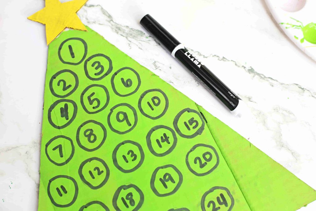 Christmas Tree Countdown Craft - Cultivating Brilliant Minds cardboard painted to look like a christmas tree with numbers on it