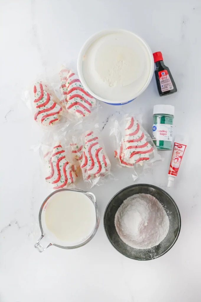 Christmas Tree Cake Trifle - Cultivating Brilliant Minds ingredients to make a christmas tree cake trifle, including little debbies christmas trees, sprinkles, and more