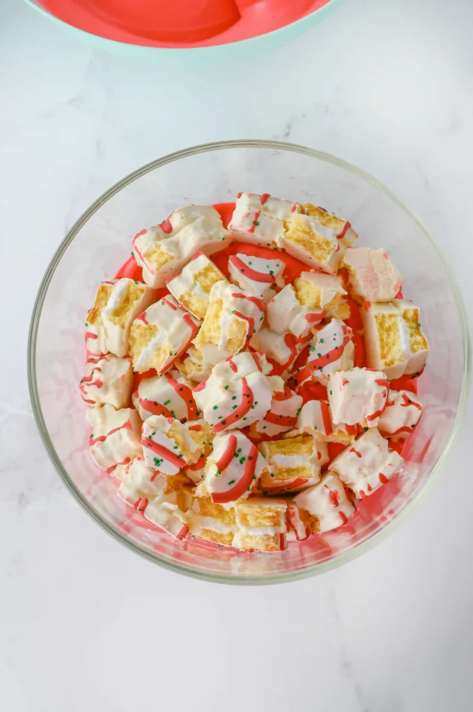 Christmas Tree Cake Trifle - Cultivating Brilliant Minds little debbie christmas tree cakes broken up into big chunks in the trifle jar