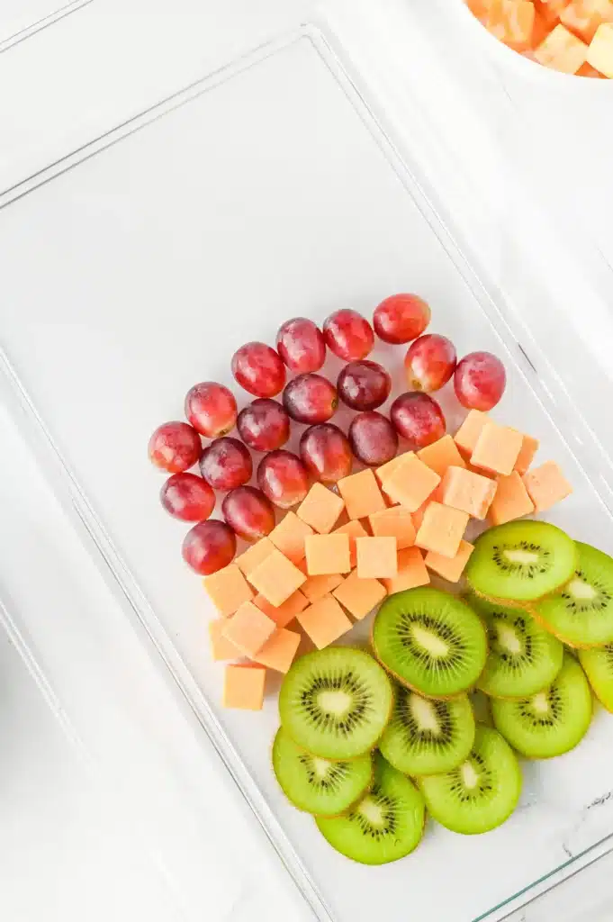 Christmas Tree Fruit Tray - Cultivating Brilliant Minds kiwi, cheese, and grapes on a tray