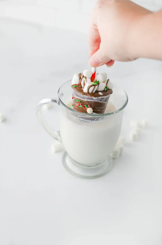 Hot Chocolate Sticks - Cultivating Brilliant Minds dipping a hot chocolate stick in a cup of milk