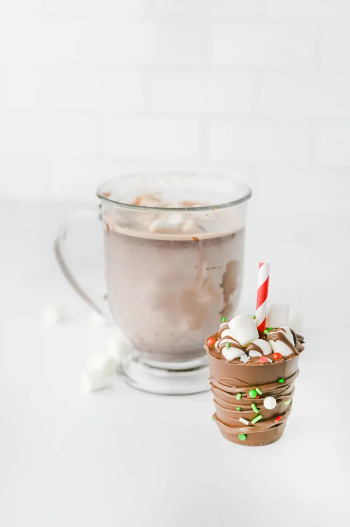 Hot Chocolate Sticks - Cultivating Brilliant Minds A hot chocolate stick next to a cup of hot chocolate