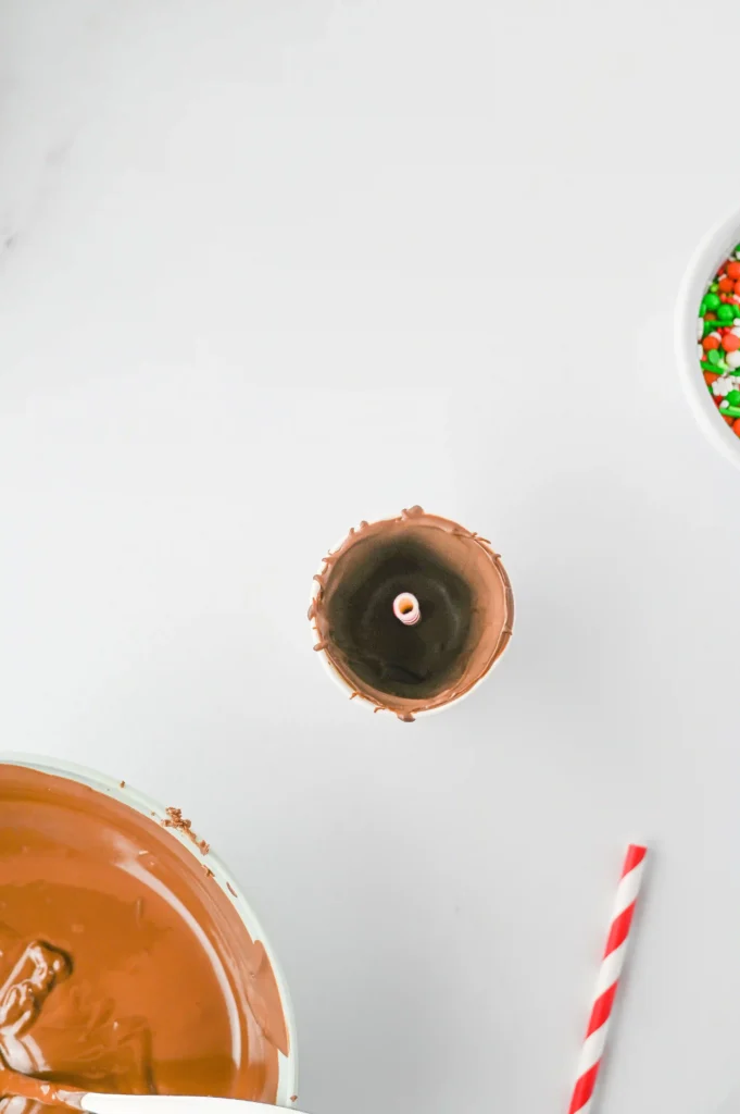 Hot Chocolate Sticks - Cultivating Brilliant Minds a cup coated with melted chocolate