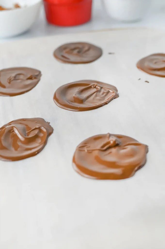 Reindeer Bark for Christmas - Cultivating Brilliant Minds chocolate circles on parchment paper