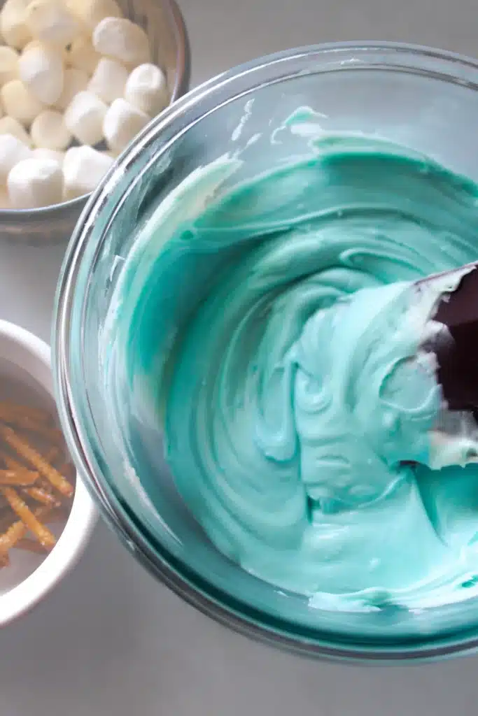 Snowglobe Bark - Cultivating Brilliant Minds blue icing in a bowl