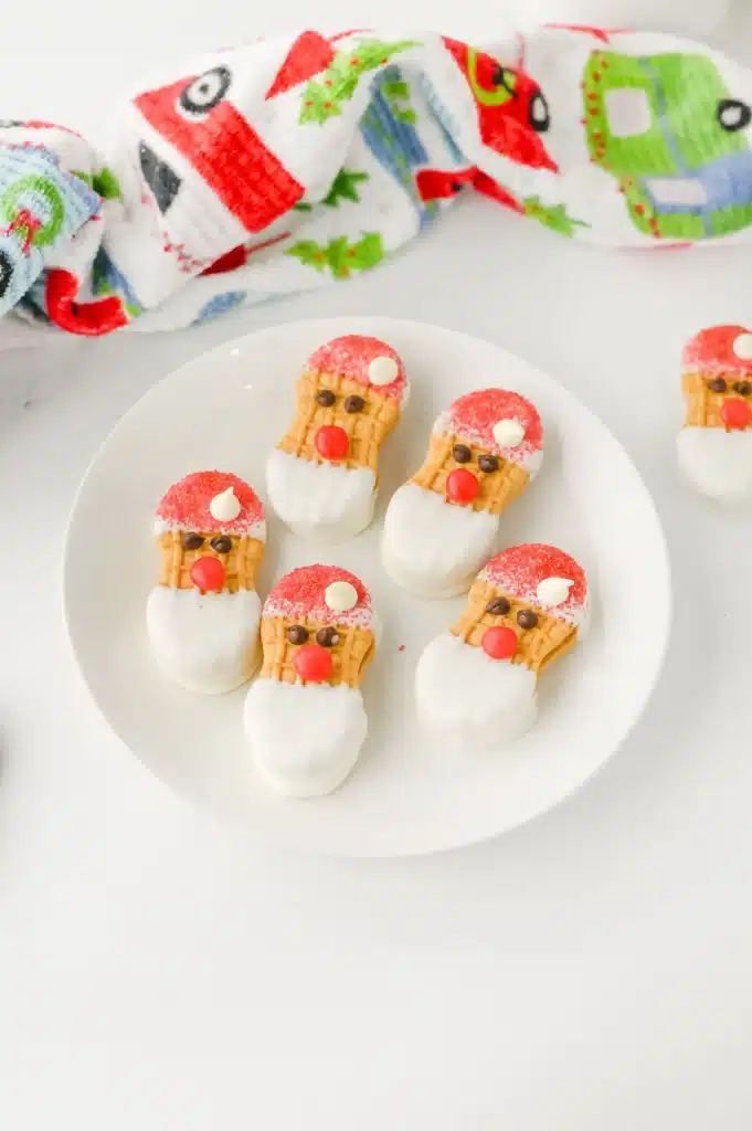 Santa Nutter Butters - Cultivating Brilliant Minds nutter butters decorated to look like Santa