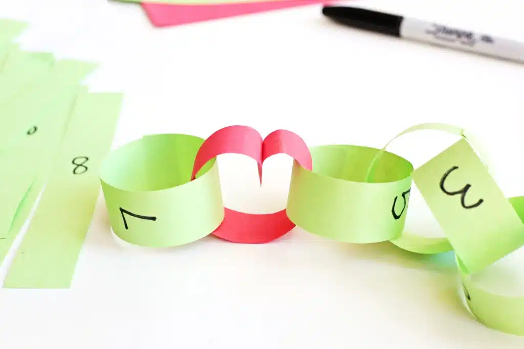 Grinch Paper Chain Countdown - Cultivating Brilliant Minds construction paper made into a paper chain to countdown the days to christmas