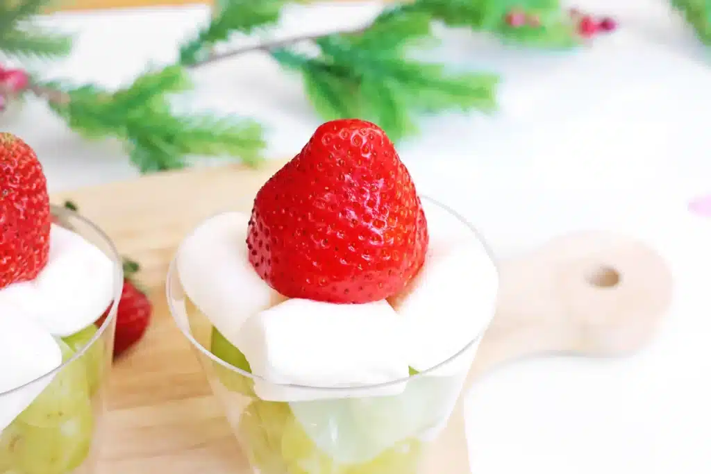 Grinch Fruit Cup - Cultivating Brilliant Minds a grinch fruit cup made with green grapes, mini marshmallows, and strawberries