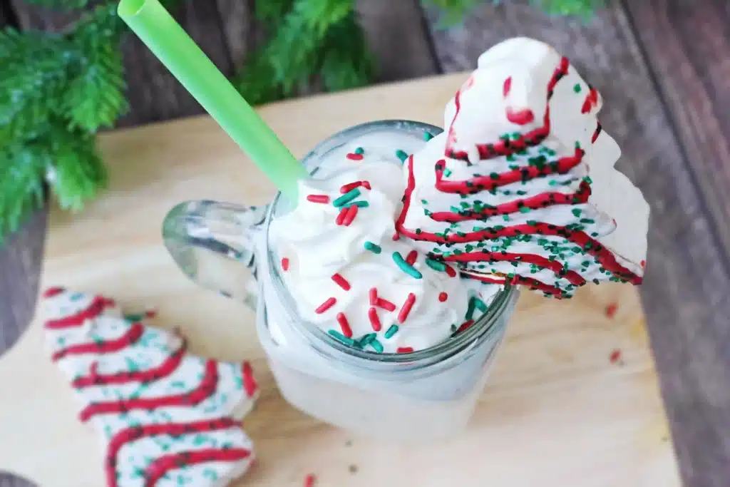 Christmas Tree Cake Milkshake - Cultivating Brilliant Minds a christmas tree cake milkshake with a little debbies christmas tree snack on top