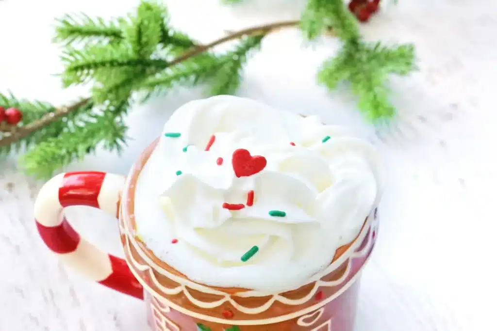 Grinch Hot Chocolate Spoons - Cultivating Brilliant Minds hot cocoa with whipped cream and sprinkles