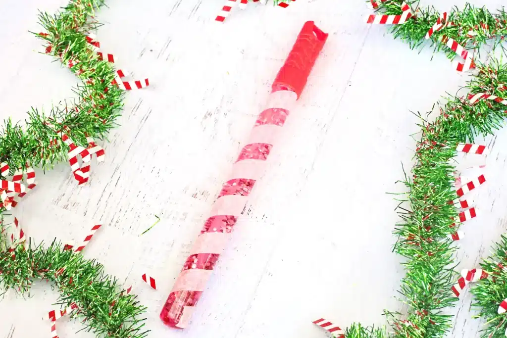 Candy Cane Sensory Wand - Cultivating Brilliant Minds a bubble wand turned into a candy cane sensory wand with glitter inside