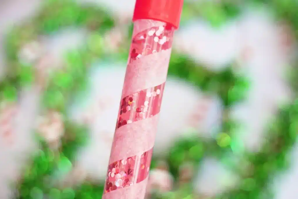 Candy Cane Sensory Wand - Cultivating Brilliant Minds a bubble wand turned into a candy cane sensory wand with glitter inside
