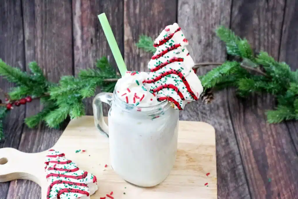 Christmas Tree Cake Milkshake - Cultivating Brilliant Minds a christmas tree cake milkshake with a little debbies christmas tree snack on top