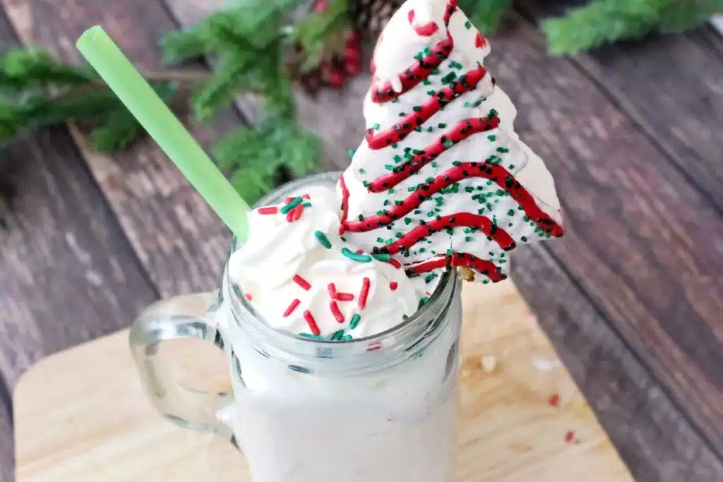 Christmas Tree Cake Milkshake - Cultivating Brilliant Minds a christmas tree cake milkshake with a little debbies christmas tree snack on top