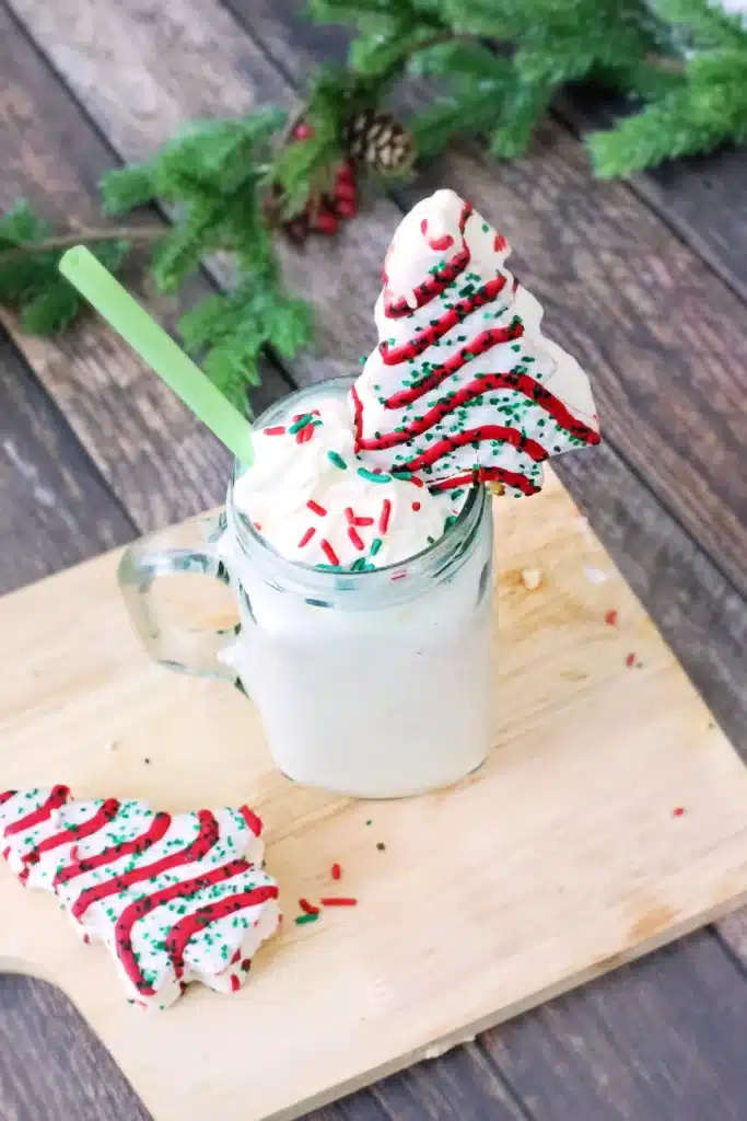 Christmas Tree Cake Milkshake - Cultivating Brilliant Minds a christmas tree cake milkshake with a little debbies christmas tree snack on top