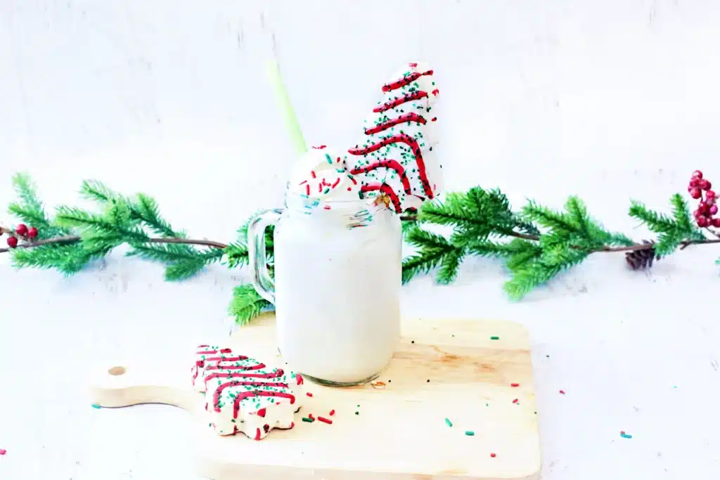 Christmas Tree Cake Milkshake - Cultivating Brilliant Minds a christmas tree cake milkshake with a little debbies christmas tree snack on top