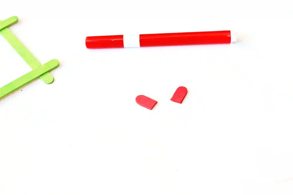 Grinch Popsicle Stick Photo Frame - Cultivating Brilliant Minds two ends of the popsicle stick cut off and painted red