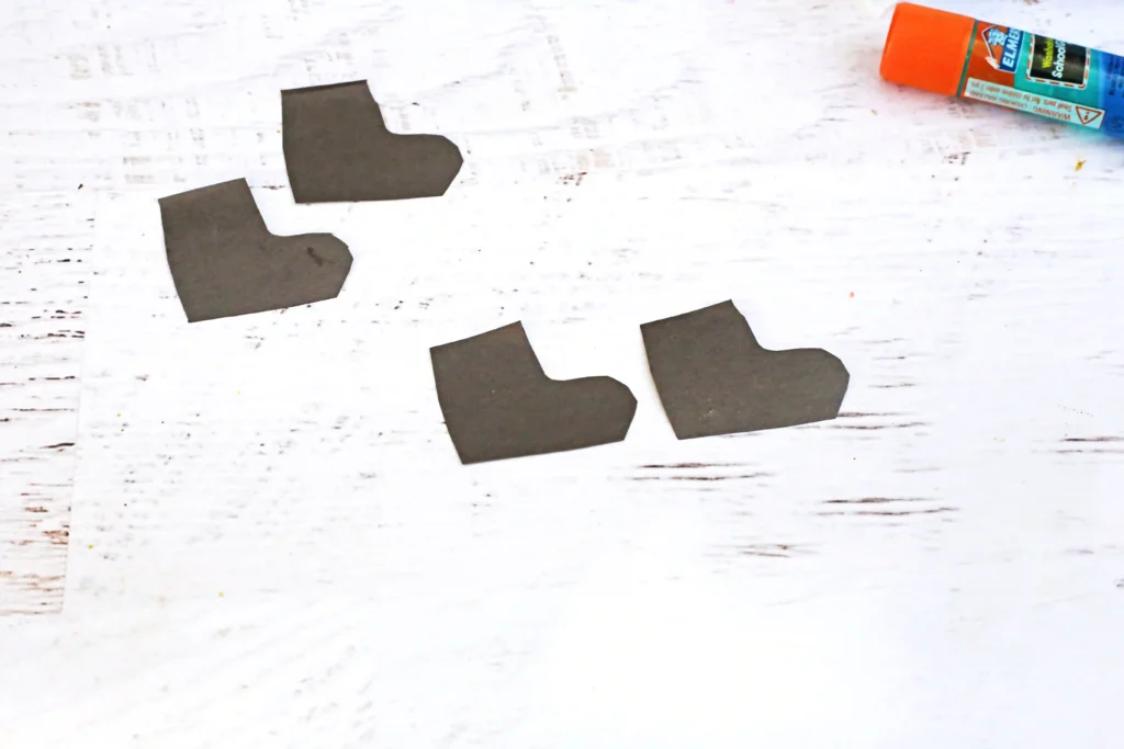 Santa in the Chimney Pudding Snack - Cultivating Brilliant Minds boots cut out of black construction paper