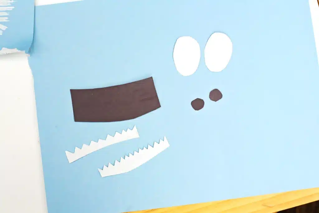 Fork Painted Abominable Snowman - Cultivating Brilliant Minds eyes and mouth pieces cut out of black and white construction paper